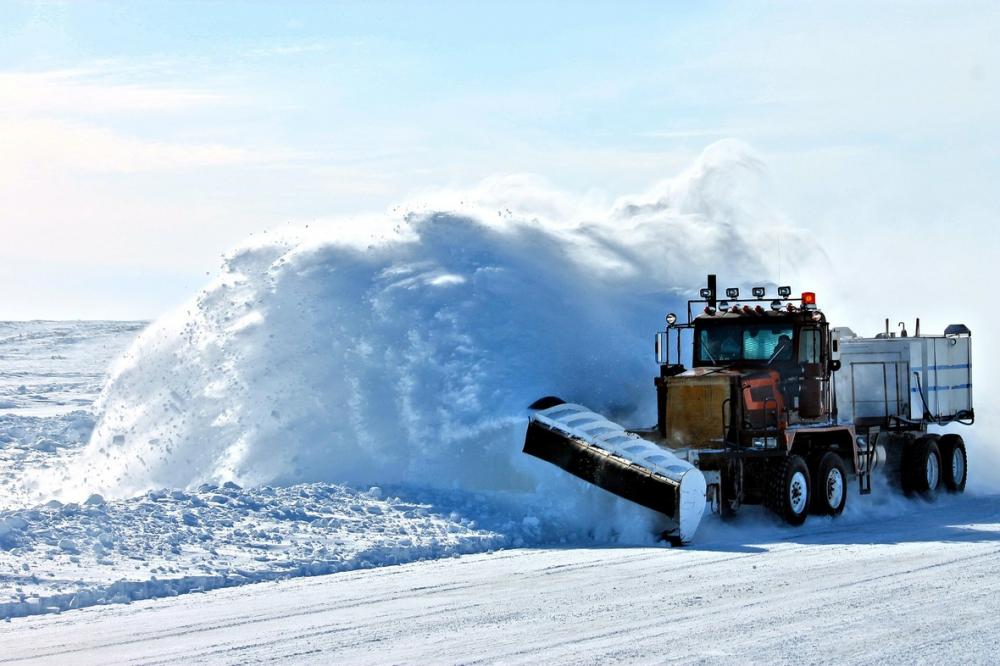 Plowing and hauling snow.